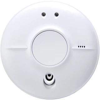 A round, white smoke detector with a central circular button and small vents on the side. It features two small indicator lights at the top for status alerts.