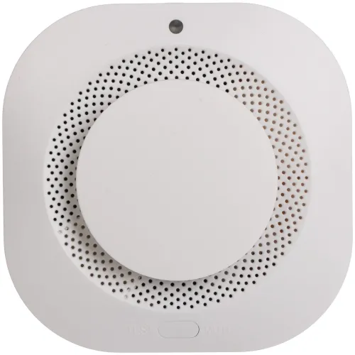 A white, square-shaped smoke detector with rounded edges features a central circular sensor and a perforated design for optimal air flow. The device includes a test and mute button at the bottom for easy functionality.