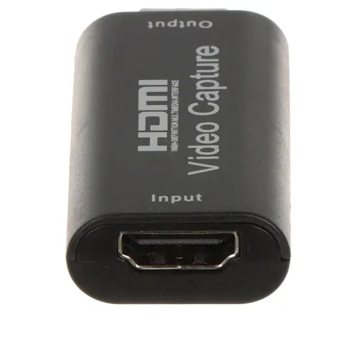 A compact HDMI video capture device with a sleek black design, featuring clearly labeled input and output ports. The device is designed for easy connection and efficient video capturing.