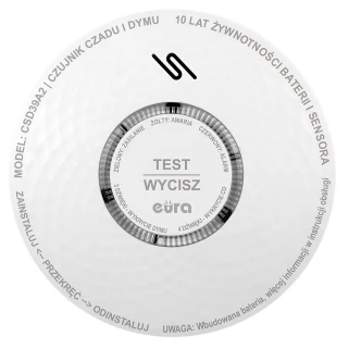 A round, white smoke and carbon monoxide detector with a central button labeled "TEST WYCISZ" and various status indicators around it. The device features a textured surface and is designed for easy installation and long battery life.