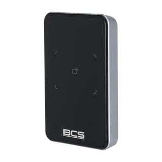 A sleek, black proximity card reader with a minimalist design and a subtle card icon in the center. The device features a smooth surface and the BCS logo at the bottom.