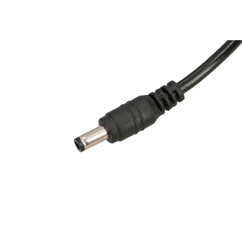 A close-up of a black DC power connector with a cylindrical metal tip and a ribbed plastic grip. The cable is partially visible, extending from the connector.