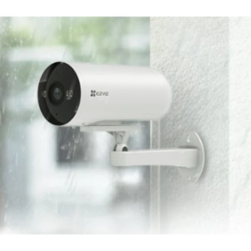 A sleek, white security camera is mounted on a wall, featuring a cylindrical design with a black front panel. The camera is positioned to overlook an outdoor area, suggesting weather-resistant capabilities.