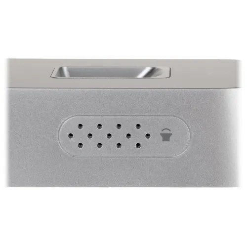 A close-up of a sleek, metallic speaker with a perforated grille design and a small icon resembling a speaker. The minimalist design emphasizes modern aesthetics and functionality.