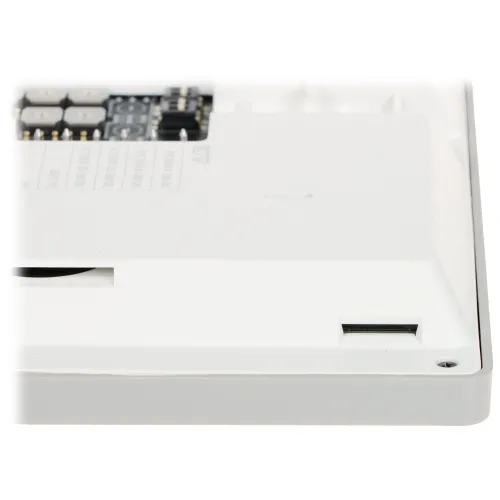 The image shows a close-up of a white electronic device featuring a memory card slot on its side. The device has a sleek design with visible circuit components and labels on the top surface.