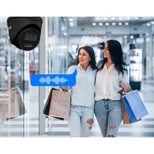 A black dome-shaped IP camera is mounted on the ceiling, featuring a sleek design and advanced audio capabilities. The camera is positioned in a modern shopping mall, capturing clear images and sound.