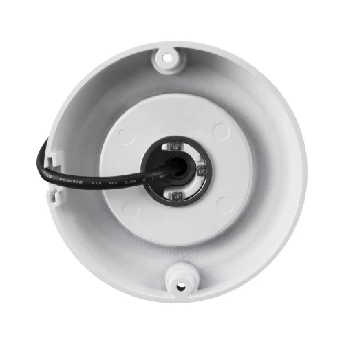 The image shows a white, dome-shaped IP camera with a central lens and a black cable extending from the back. The camera is designed for ceiling mounting and features a sturdy, circular base with screw holes for secure installation.