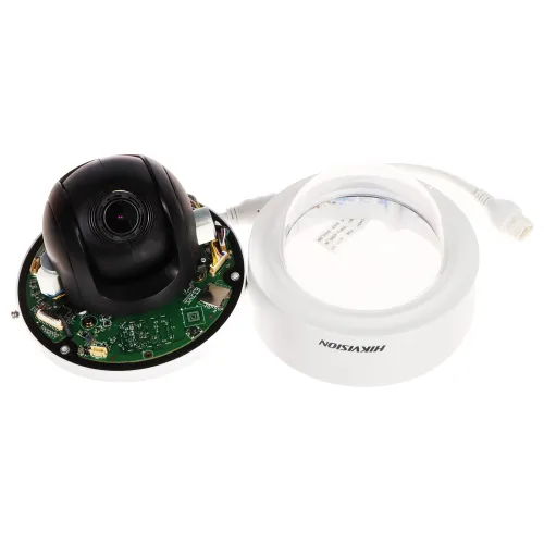 The image shows a disassembled security camera with its internal components exposed, including a circuit board and lens. Next to it is the camera's white outer casing with a clear dome and a visible brand logo.