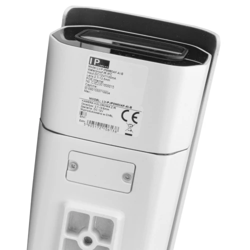 A white, rectangular IP camera with a sleek design, featuring a lens at the top and a label with technical specifications on the back. The camera is designed for outdoor surveillance, offering durability and advanced monitoring capabilities.