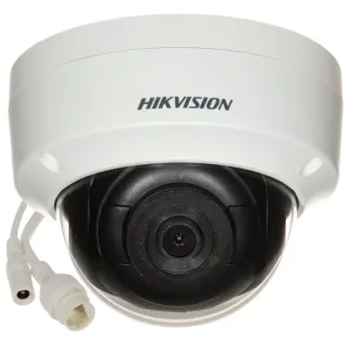 A white, dome-shaped Hikvision security camera with a black lens is shown, featuring a vandal-resistant design. The camera includes visible connection cables for easy installation.