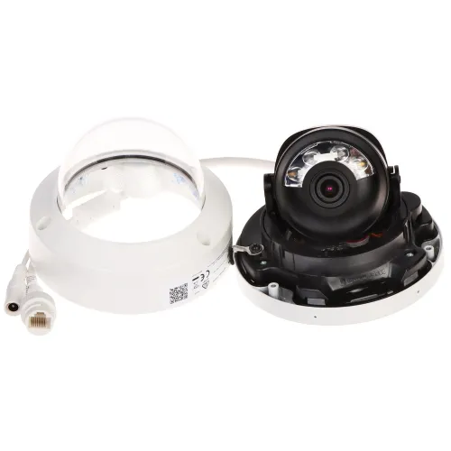 A disassembled dome security camera is shown with its lens and internal components exposed, alongside the outer casing and connecting cables. The camera features a compact design suitable for discreet surveillance installations.