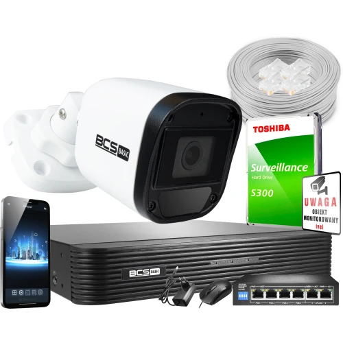 The image features a comprehensive security system package, including a BCS Basic surveillance camera, a Toshiba S300 hard drive, and a BCS Basic network video recorder. Additional components include a smartphone displaying a security app, a network switch, Ethernet cables, and a warning sign for monitored areas.
