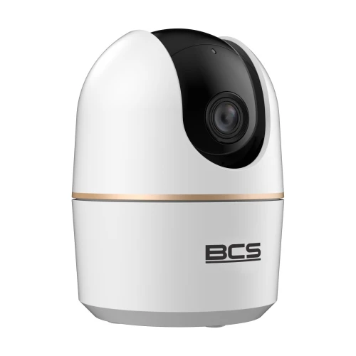 A sleek, white indoor security camera with a black lens and gold accent, designed for 360-degree rotation. The compact device features the BCS logo on its front, offering modern surveillance capabilities.