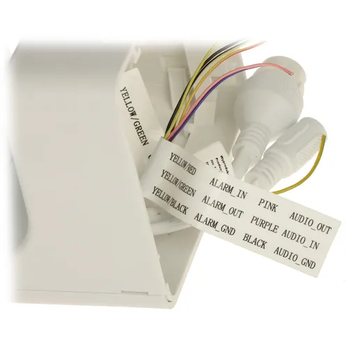 A close-up of a white electronic device with multiple colored wires and labeled connectors for audio and alarm functions. The labels include descriptions such as "YELLOW/GREEN," "ALARM IN," and "AUDIO OUT."
