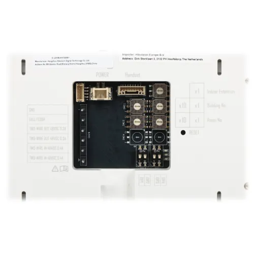 The image shows the back panel of an electronic device featuring multiple connection ports and labeled terminals for wiring. The circuit board is prominently displayed, highlighting various components and connectors for installation.