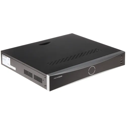 The image shows a sleek, black Hikvision IP recorder with a minimalist design and a circular control interface on the front panel. It features multiple ventilation slots on the side for efficient cooling and two USB ports for connectivity.