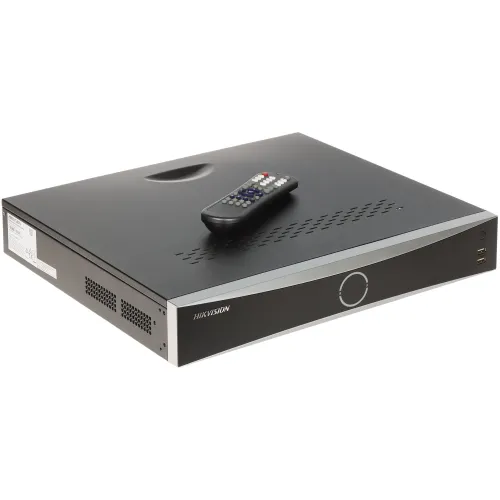 The image shows a sleek black Hikvision IP recorder with a minimalist design, featuring a circular power button on the front panel. A remote control is placed on top, highlighting its user-friendly operation.