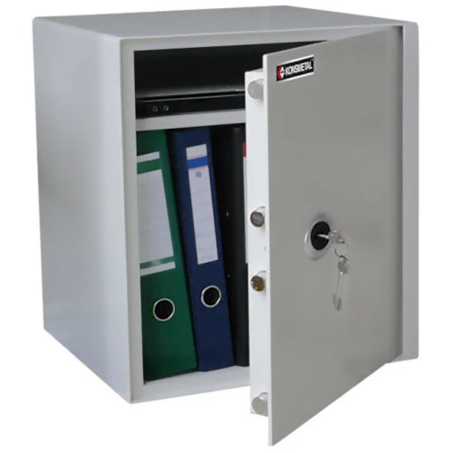 A freestanding Konsmetal safe with a white finish is shown with its door open, revealing storage space containing binders and a laptop. The safe features a key lock mechanism for secure access.