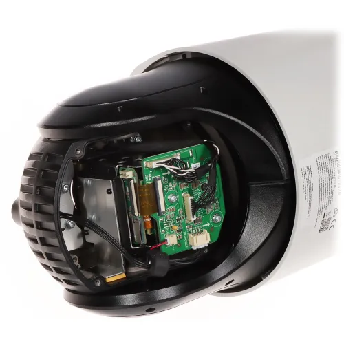 The image shows the internal components of a security camera, revealing its circuit board and wiring. The camera housing is partially removed, displaying the intricate electronic setup inside.