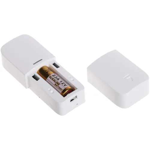 A white plastic enclosure is shown open, revealing a 12V alkaline battery inside. The cover is placed beside the main body, highlighting the battery compartment.