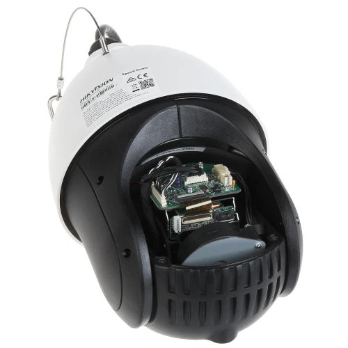 The image shows the interior of a dome security camera, revealing its electronic components and wiring. The camera's outer casing is partially open, displaying the intricate design and technology inside.