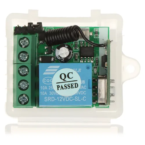 The image shows an open electronic enclosure revealing a circuit board with a relay and several components, including a coiled wire and terminal connectors. A "QC PASSED" sticker is prominently displayed on the relay, indicating quality control approval.