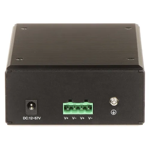 A black, rectangular electronic device with a ribbed top surface features a power input on the left and a green terminal block with four connection points in the center. The device also includes a grounding screw on the right side, designed for secure electrical installations.