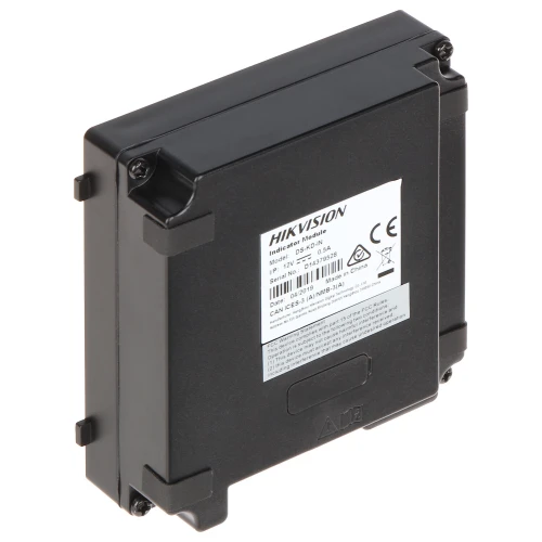 The image shows a black Hikvision intercom module with a rectangular shape and a durable casing. The back of the module features a label with technical specifications and compliance markings.