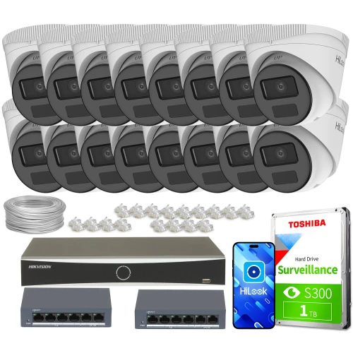 The image shows a comprehensive surveillance system package, including sixteen dome IP cameras, a Hikvision network video recorder, and a Toshiba 1TB surveillance hard drive. Additional components include two network switches, a bundle of cables, and multiple connectors, providing a complete setup for monitoring needs.