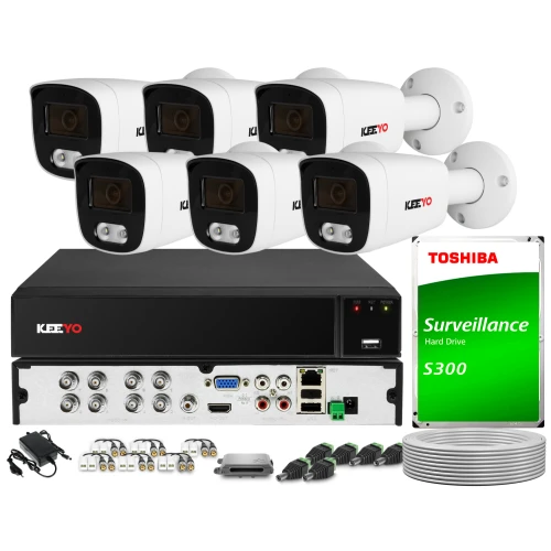 The image shows a comprehensive surveillance system featuring five white bullet cameras and a black digital video recorder. Included are various cables, connectors, a power adapter, and a Toshiba surveillance hard drive for efficient monitoring and storage.