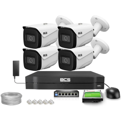 The image shows a complete surveillance system featuring four BCS bullet cameras, a digital video recorder, and essential accessories like cables and connectors. The setup includes a hard drive for storage and a mouse for easy navigation.