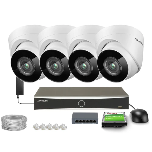 The image shows a complete surveillance system package, including four white security cameras, a recording unit, a hard drive, a network switch, cables, and connectors. This setup is designed for comprehensive monitoring and recording, suitable for both residential and commercial use.