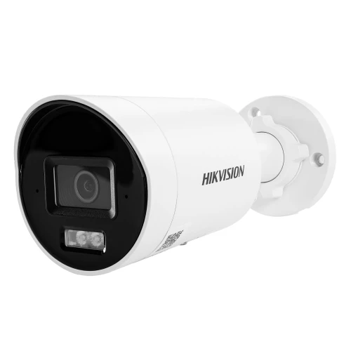 A white Hikvision security camera with a sleek, cylindrical design is shown, featuring a prominent lens and LED lights on the front. The camera is mounted on a round base, suitable for outdoor surveillance.
