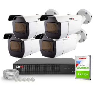 The image shows a surveillance system package featuring four white security cameras with black accents, designed for outdoor use. Included in the set are a digital video recorder, a Toshiba surveillance hard drive, cables, and connectors for comprehensive monitoring solutions.