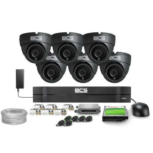 The image shows a comprehensive surveillance system featuring six black dome cameras, a central recording unit, and various accessories including cables and connectors. The set also includes a Toshiba surveillance hard drive and a mouse for system navigation.
