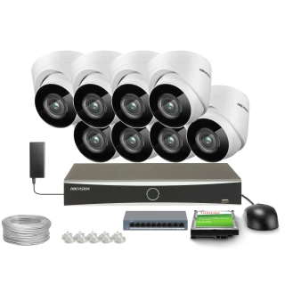 The image shows a complete surveillance system package, including eight dome cameras, a digital video recorder, a power adapter, and necessary cables. The set also features a hard drive and a network switch for comprehensive security monitoring.