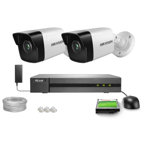 The image shows a surveillance kit featuring two Hikvision security cameras, a HiLook DVR, and a Toshiba surveillance hard drive. Additional components include a power adapter, Ethernet cables, and connectors.