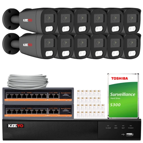 The image shows a comprehensive IP surveillance system featuring twelve black security cameras, a network video recorder, and a Toshiba surveillance hard drive. Included are two network switches, a bundle of Ethernet cables, and connectors for easy installation.