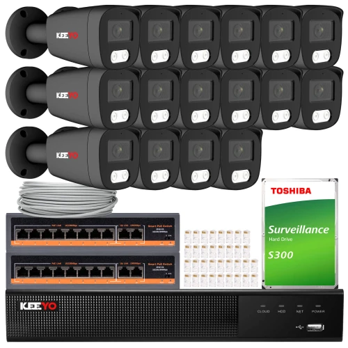 The image shows a comprehensive IP surveillance system featuring multiple black security cameras, a network video recorder, and a Toshiba surveillance hard drive. The set also includes Ethernet cables and connectors, providing a complete solution for monitoring and recording.