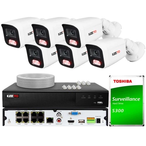 The image shows a comprehensive surveillance system featuring six white Keeyo security cameras and a black digital video recorder with multiple connectivity ports. Included in the set are a Toshiba surveillance hard drive, a coil of cable, and several connectors for installation.