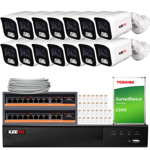 The image shows a comprehensive surveillance system package, including twelve white security cameras, a network video recorder, a Toshiba surveillance hard drive, and necessary cables and connectors. This setup is designed for extensive monitoring and recording, suitable for both residential and commercial use.