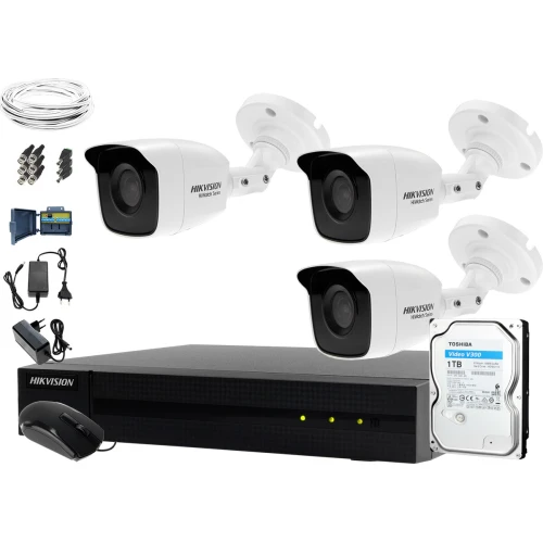 The image shows a comprehensive surveillance system package, including three Hikvision cameras, a recording unit, a 1TB Toshiba hard drive, and various cables and connectors. This setup is designed for monitoring large areas, providing high-quality video recording and storage solutions.