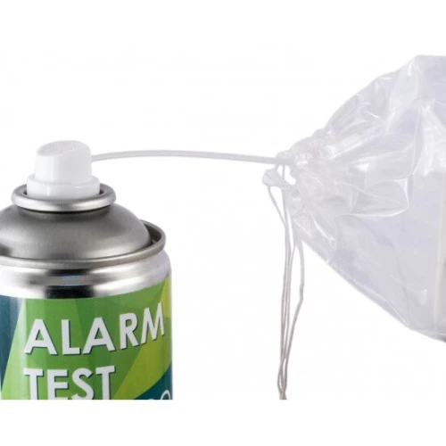 A can of alarm test spray is shown with a clear plastic bag attached to a white tube. The spray is designed for testing smoke detectors and other alarm systems.