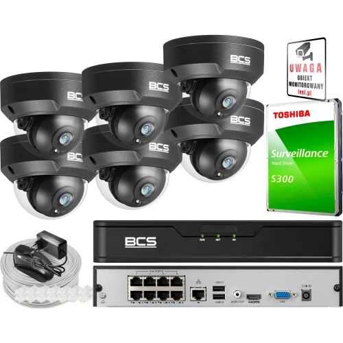 The image shows a complete surveillance system package, including six BCS vandal-proof dome cameras, a BCS network video recorder, and a Toshiba surveillance hard drive. Additional accessories such as cables and a warning sign are also included.