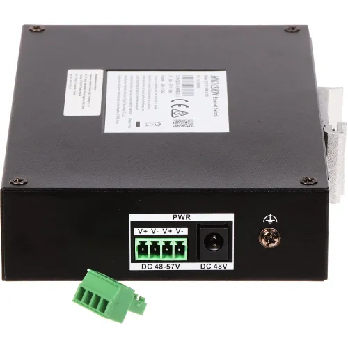 The image shows a black power supply unit with a green terminal block connector and a DC input labeled for 48V. The unit features multiple connection ports and a label with technical specifications on its surface.